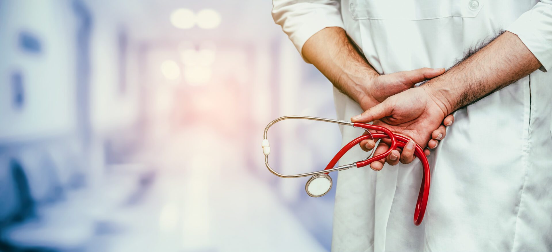 Young male doctor working at the hospital. Young male doctor working at the hospital. Medical healthcare and doctor staff service.